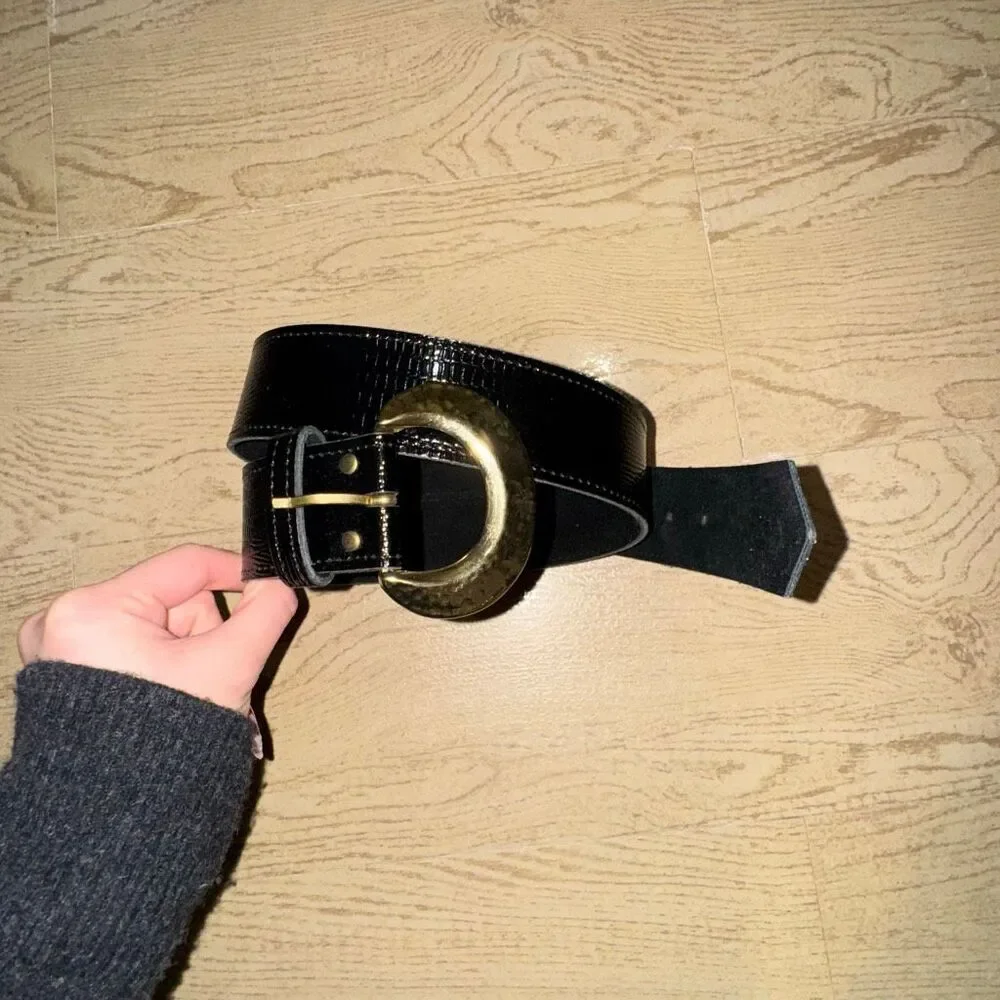 black patent leather belt with a large gold buckle, possibly a vintage 80's styl